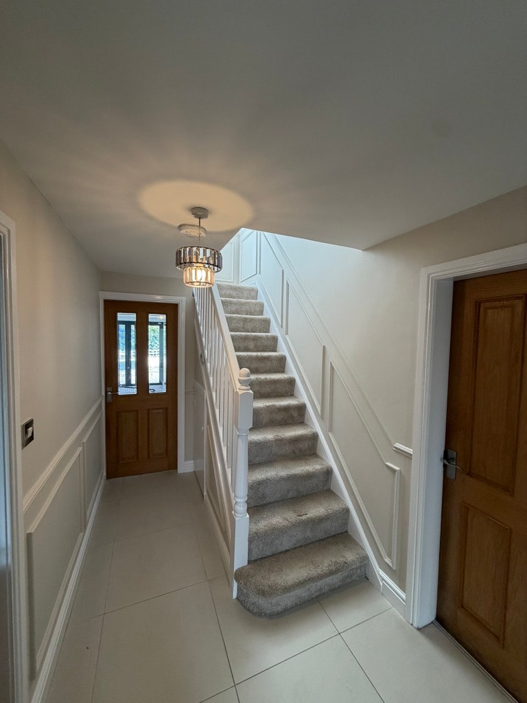 Modern staircase with black railing and skylight — decorating project