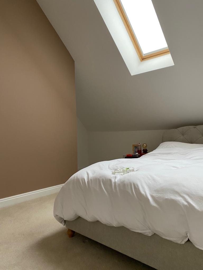 Minimalist attic bedroom with skylight — interior decorating project