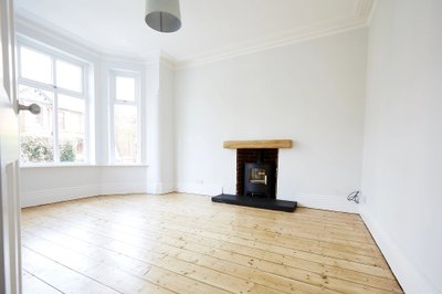 Freshly decorated living room with light wooden flooring and contemporary fireplace